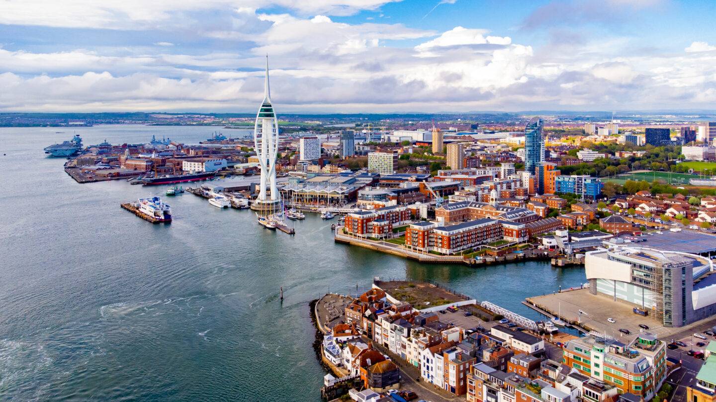 Aerial view of the sail-shaped Spinnaker Tower in Portsmouth Harbor in the south of England on the Channel coast - Gunwharf Quays modern shopping mall in a residential waterfront area