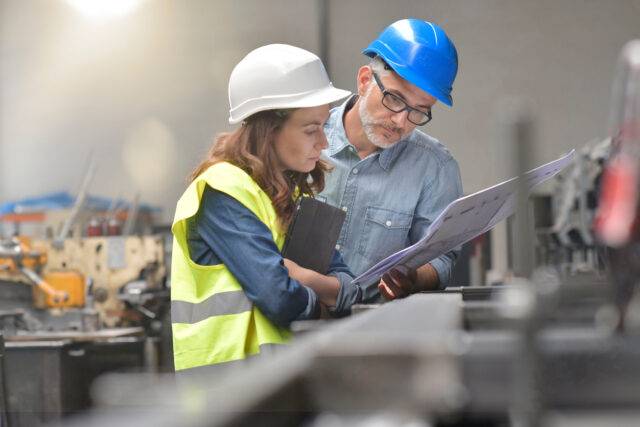 Metal industry manager and engineer meeting in factory