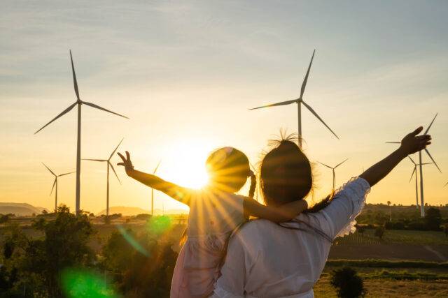 Wind turbines are alternative electricity sources, the concept of sustainable resources, People in the community with wind generators turbines, Renewable energy.