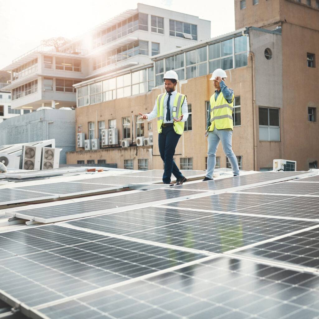 People inspecting solar panels